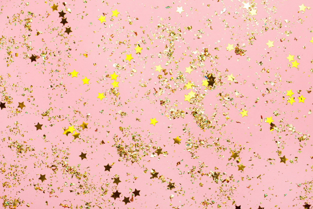 Pink confetti and golden stars and sparkles on pink background. 